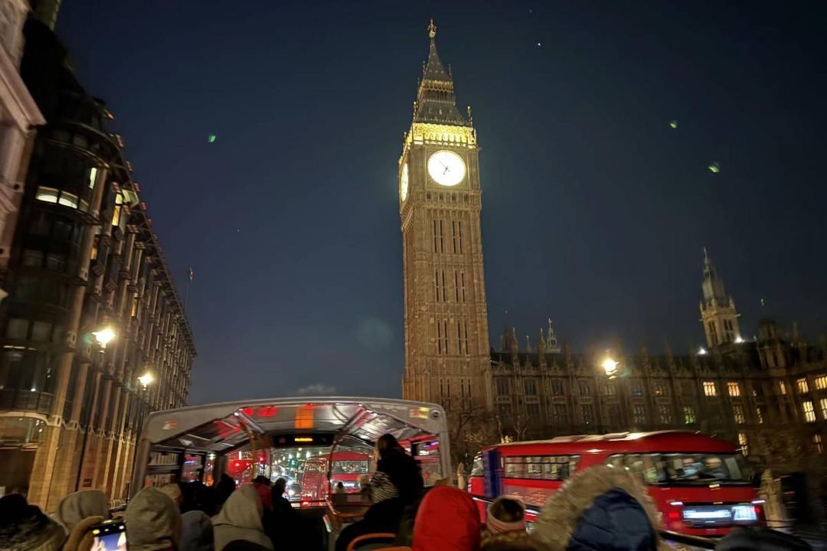 a clock tower with big ben in london at night