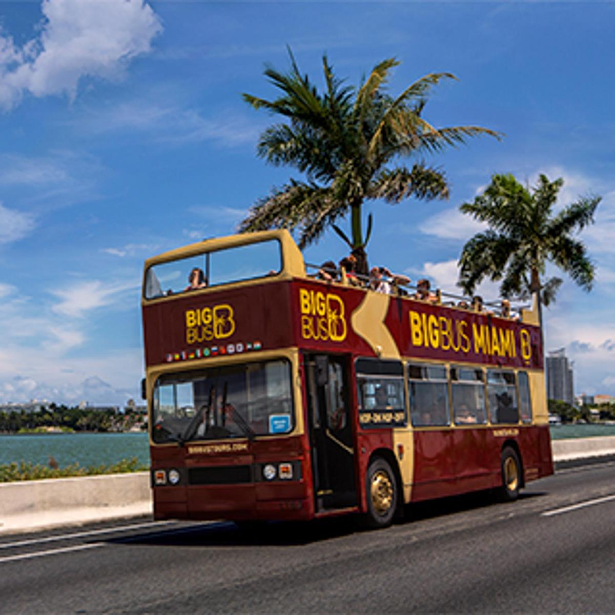 a red double decker bus driving down a street