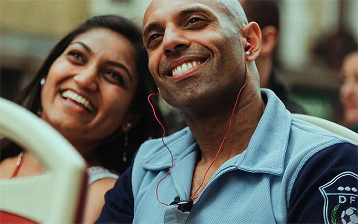 a man with ear buds in his ears with a woman