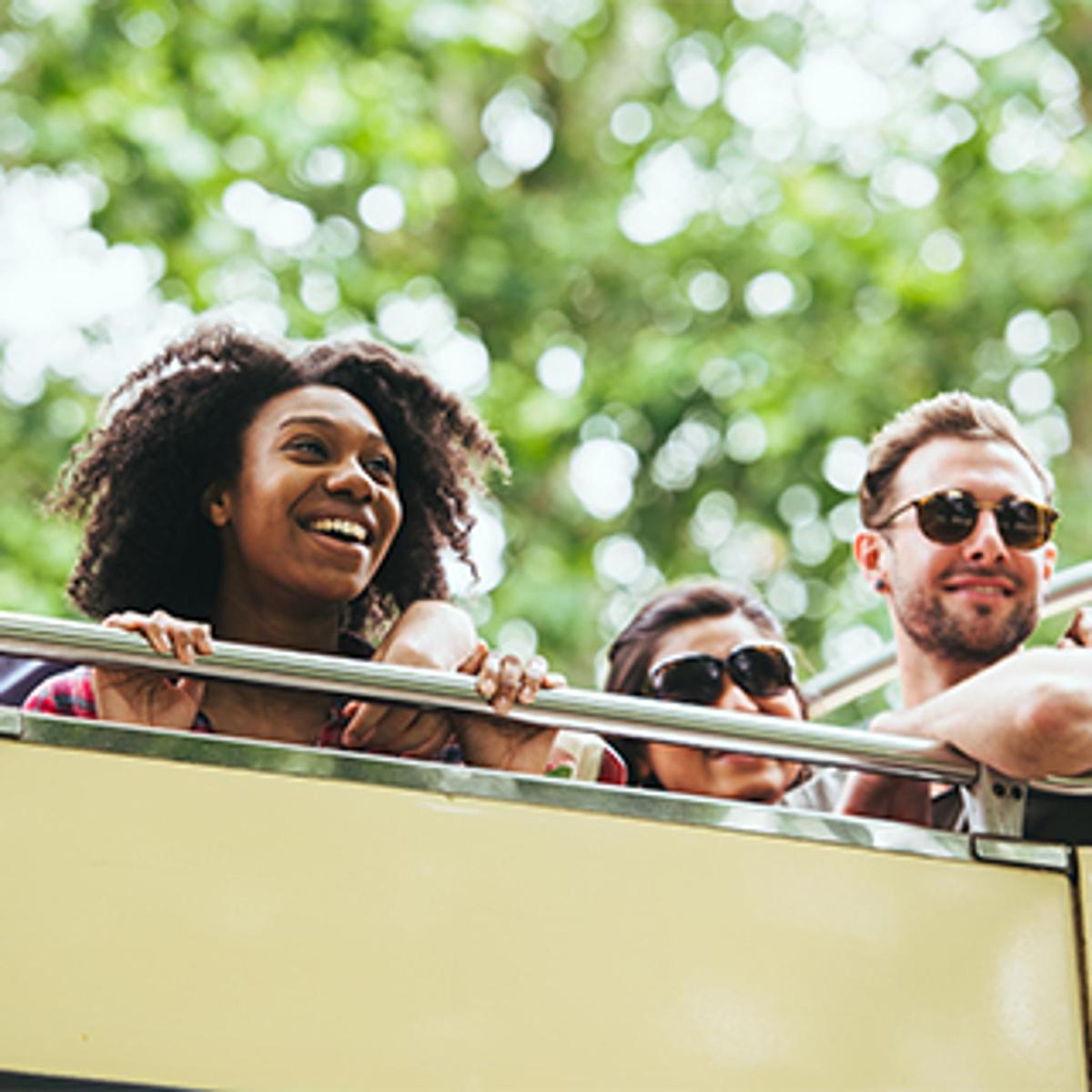 a group of people riding on a double decker bus