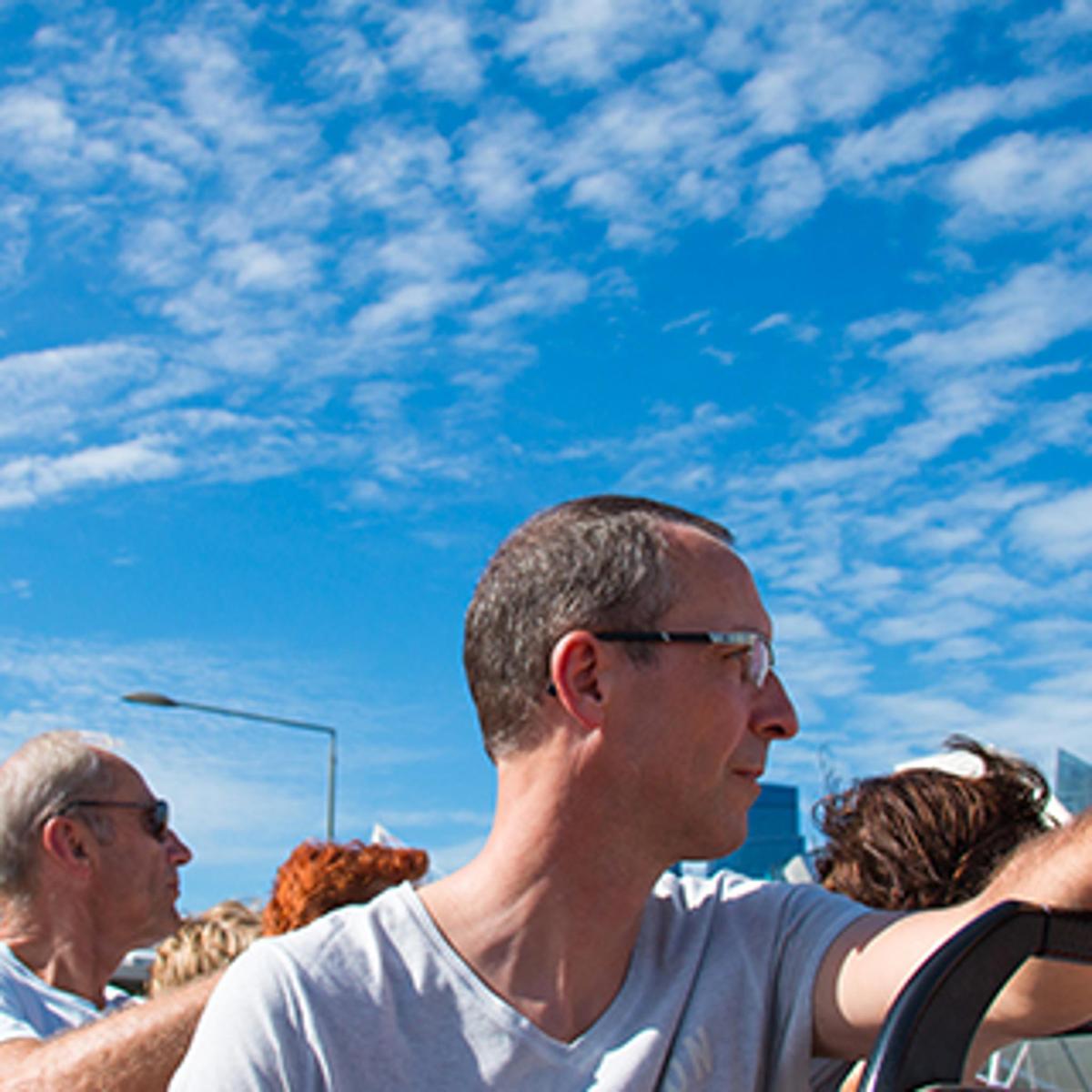 a group of people sitting in a chair looking up at the sky