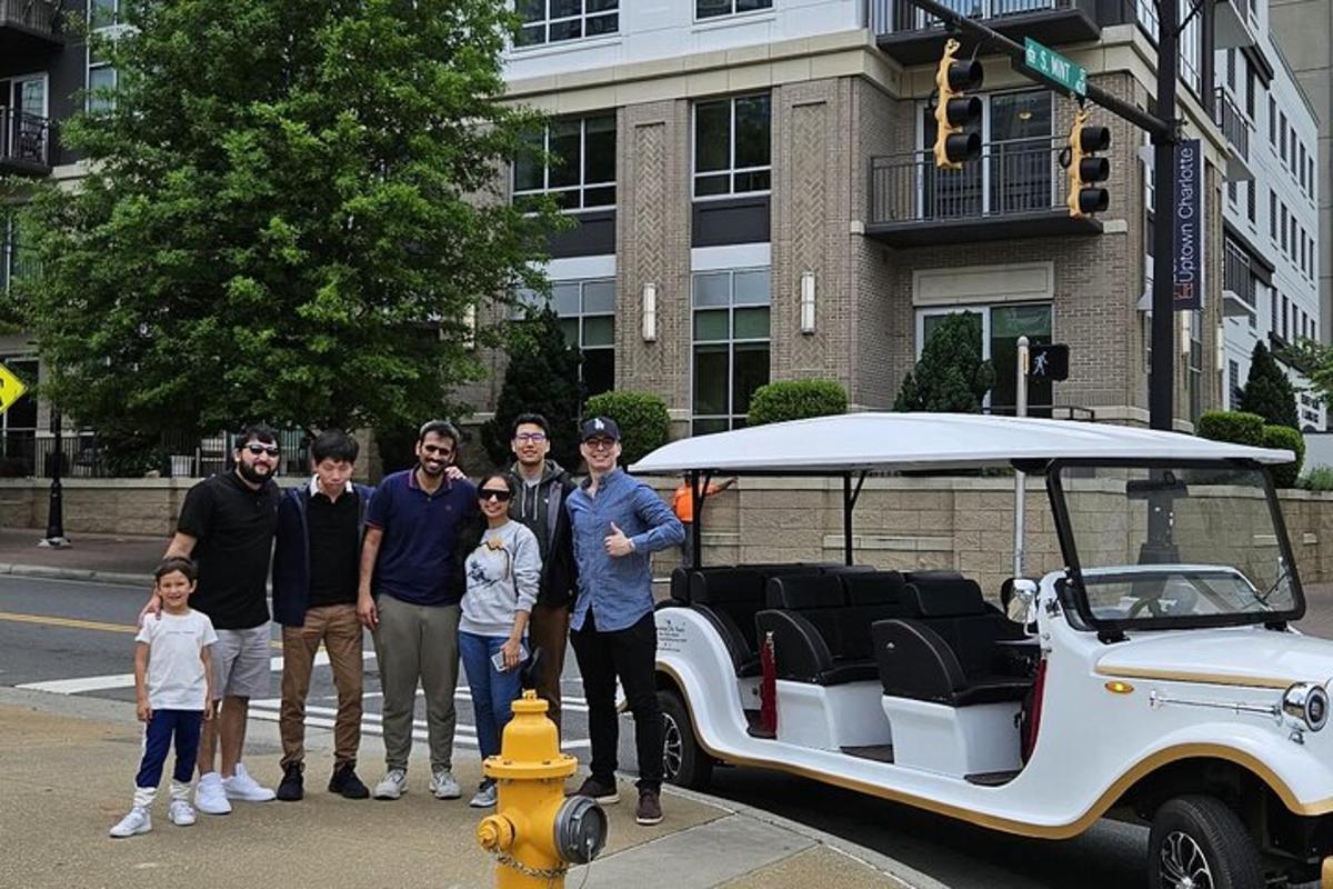 a group of people standing in front of a golf cart