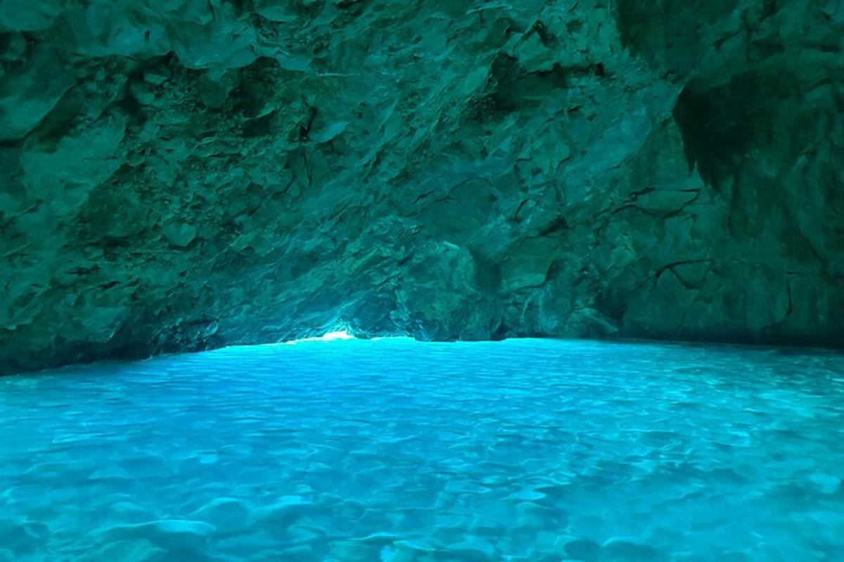 a blue cave with blue water in it