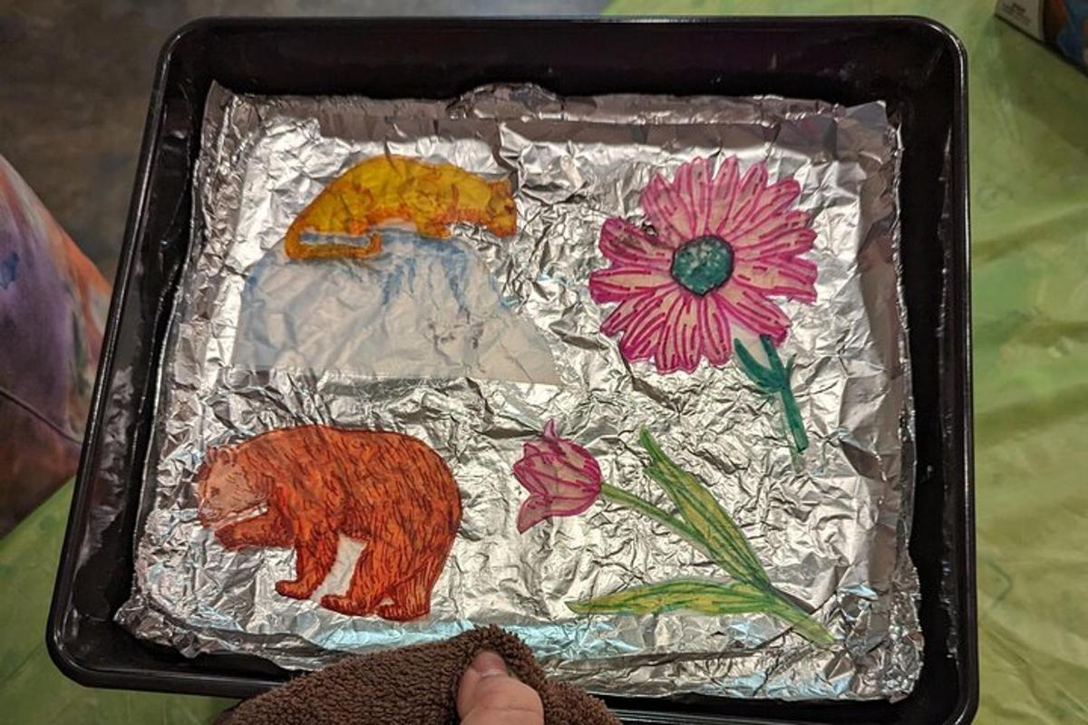 a cake with a cat and flowers on it