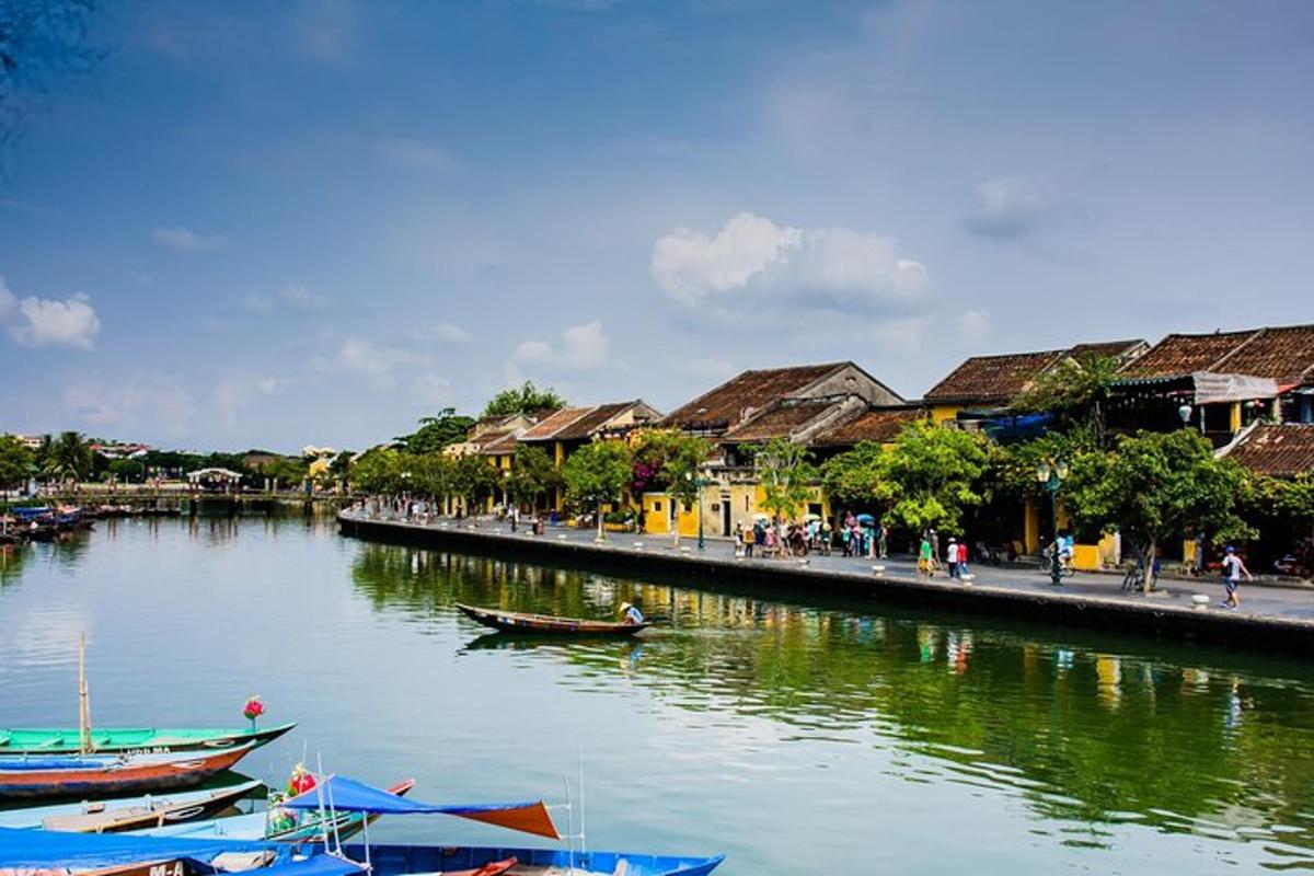 a group of boats in a river next to buildings