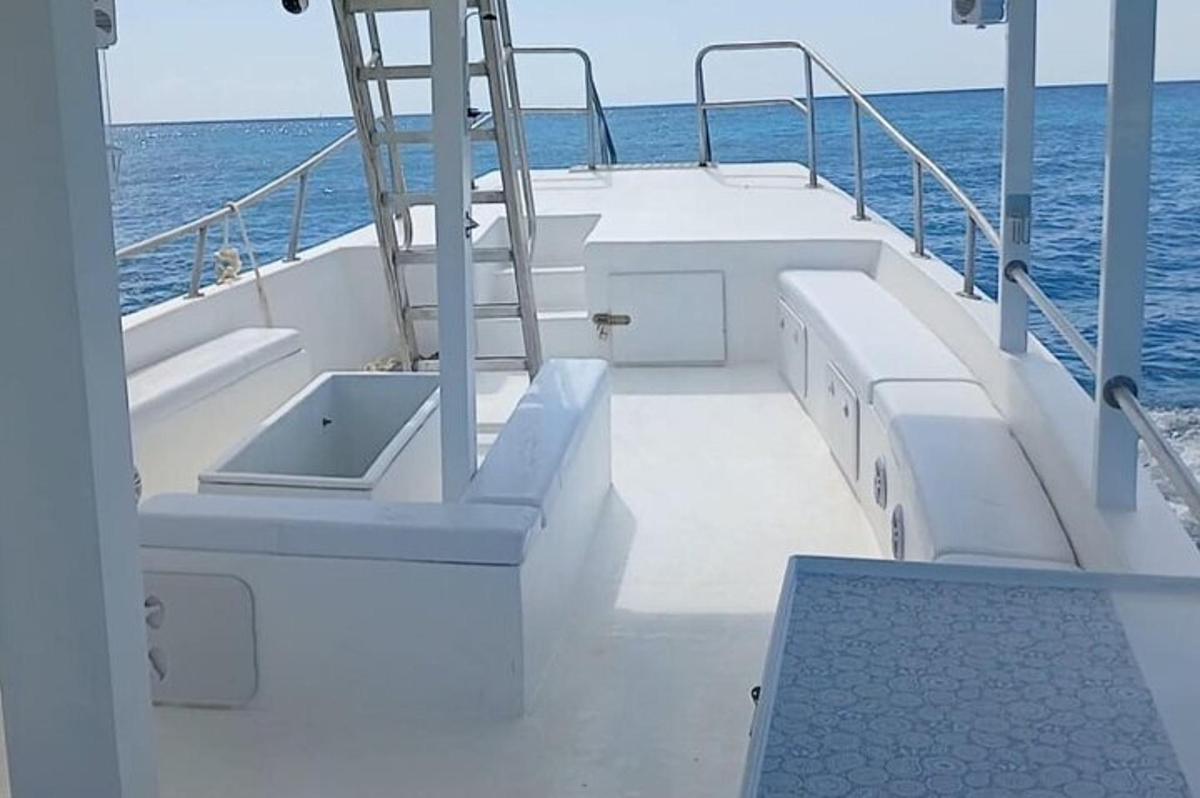 a boat deck with a sink on the water
