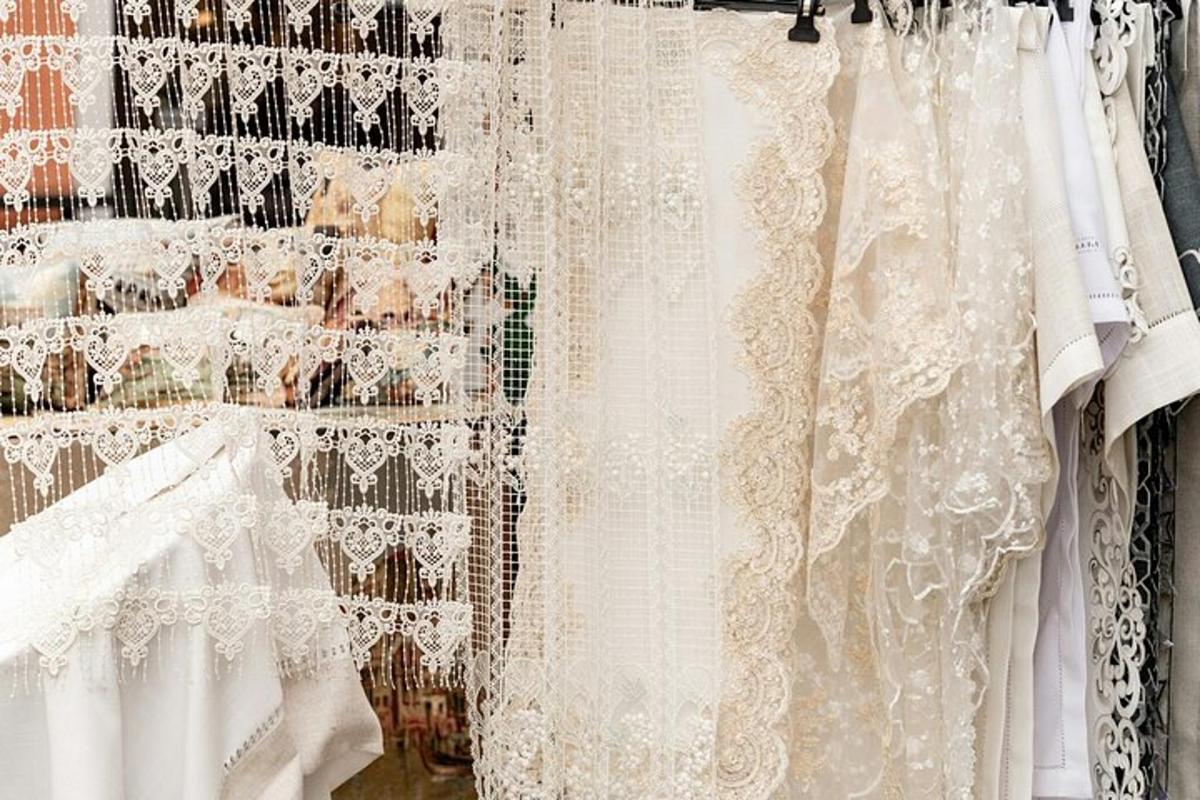 a group of white lace dresses on a rack