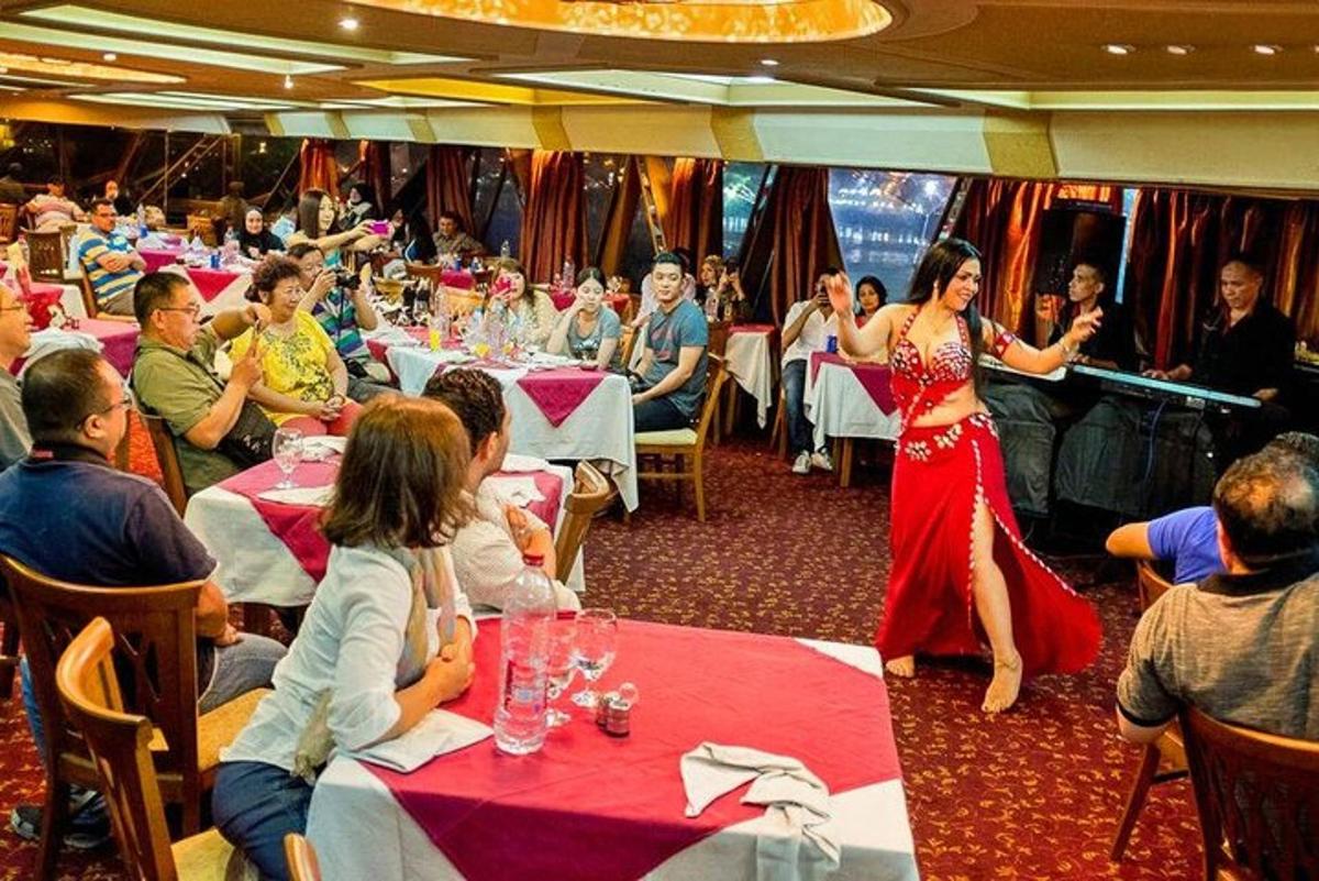 a woman in a red dress standing in a restaurant