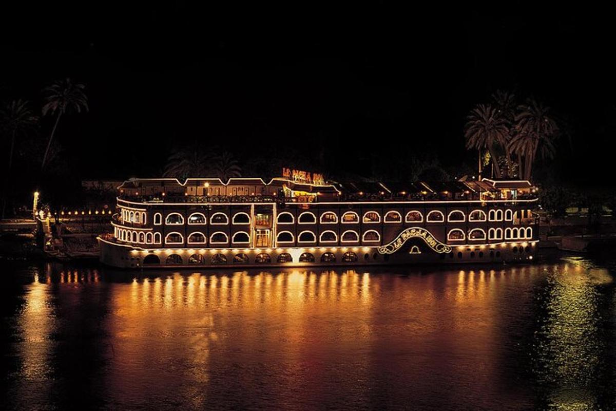 a large building on the water at night