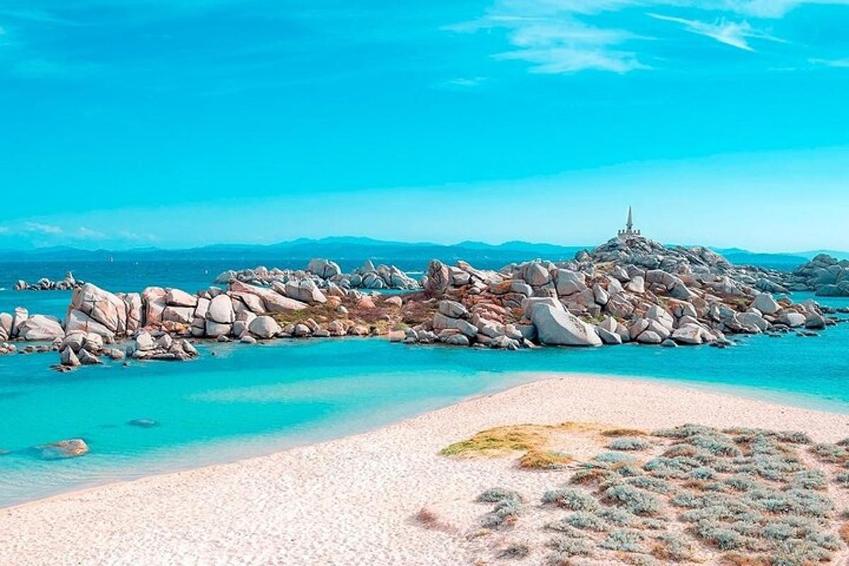 a beach with a bunch of rocks and blue water