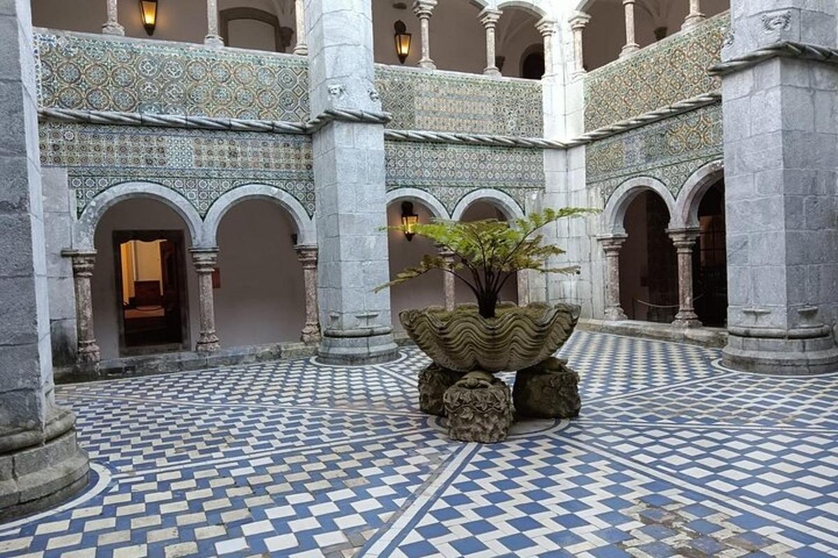 a courtyard with a plant in the middle of a building