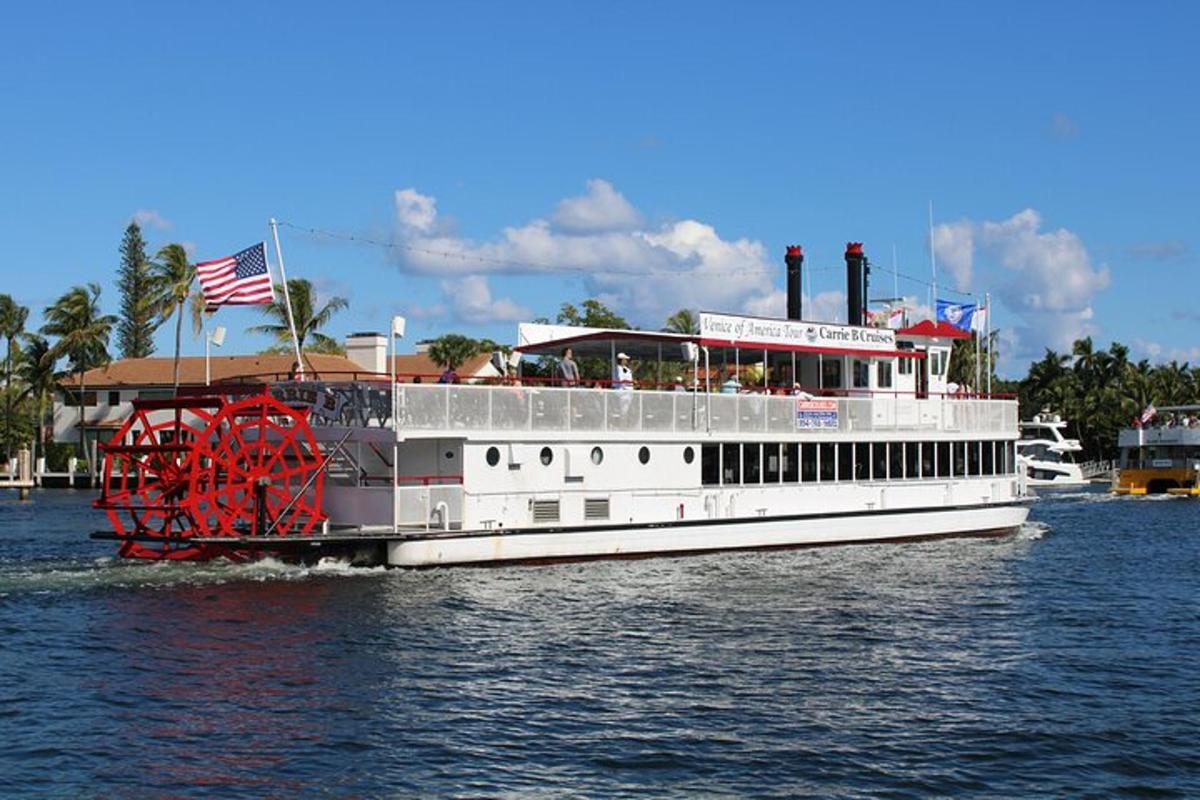 a white boat on the water with an american flag