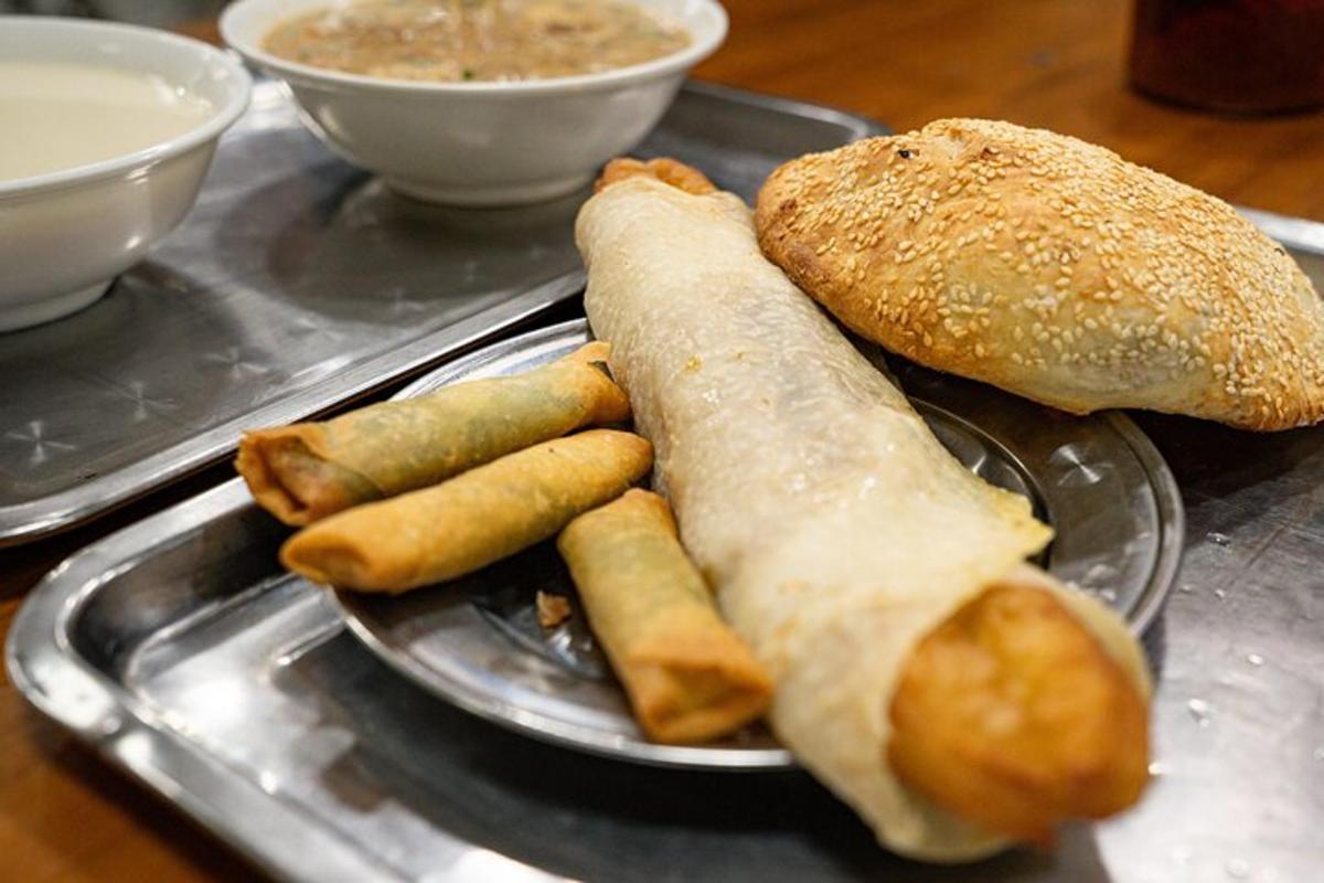 a plate with a sandwich and some rolls and bread