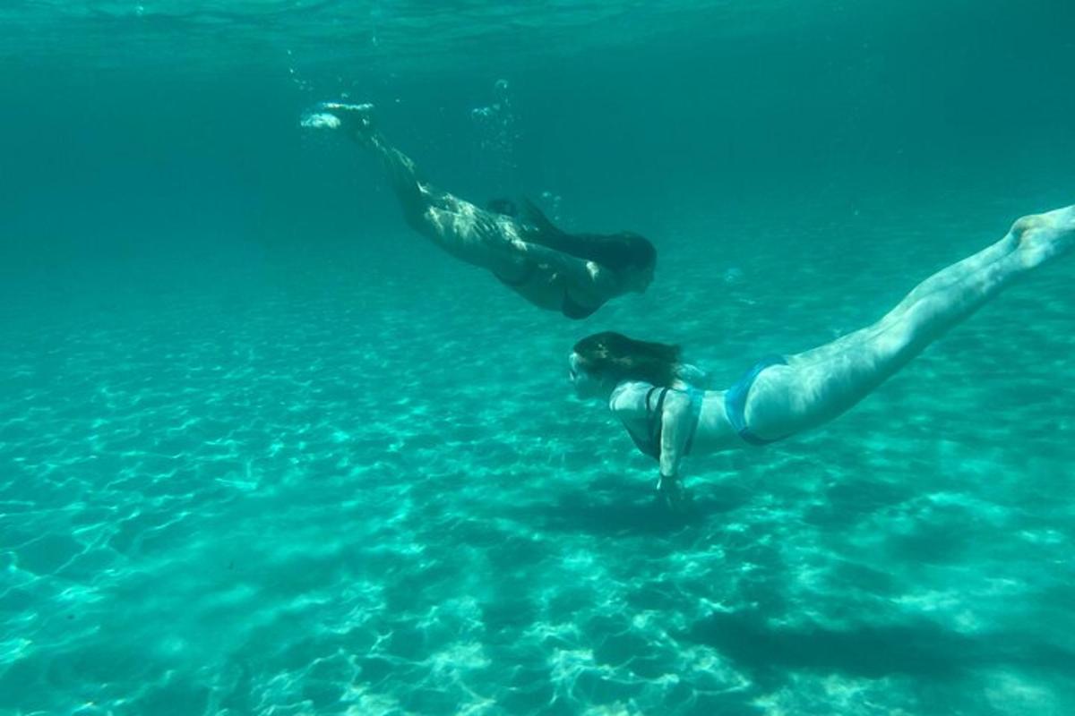 two people swimming in the water in the ocean