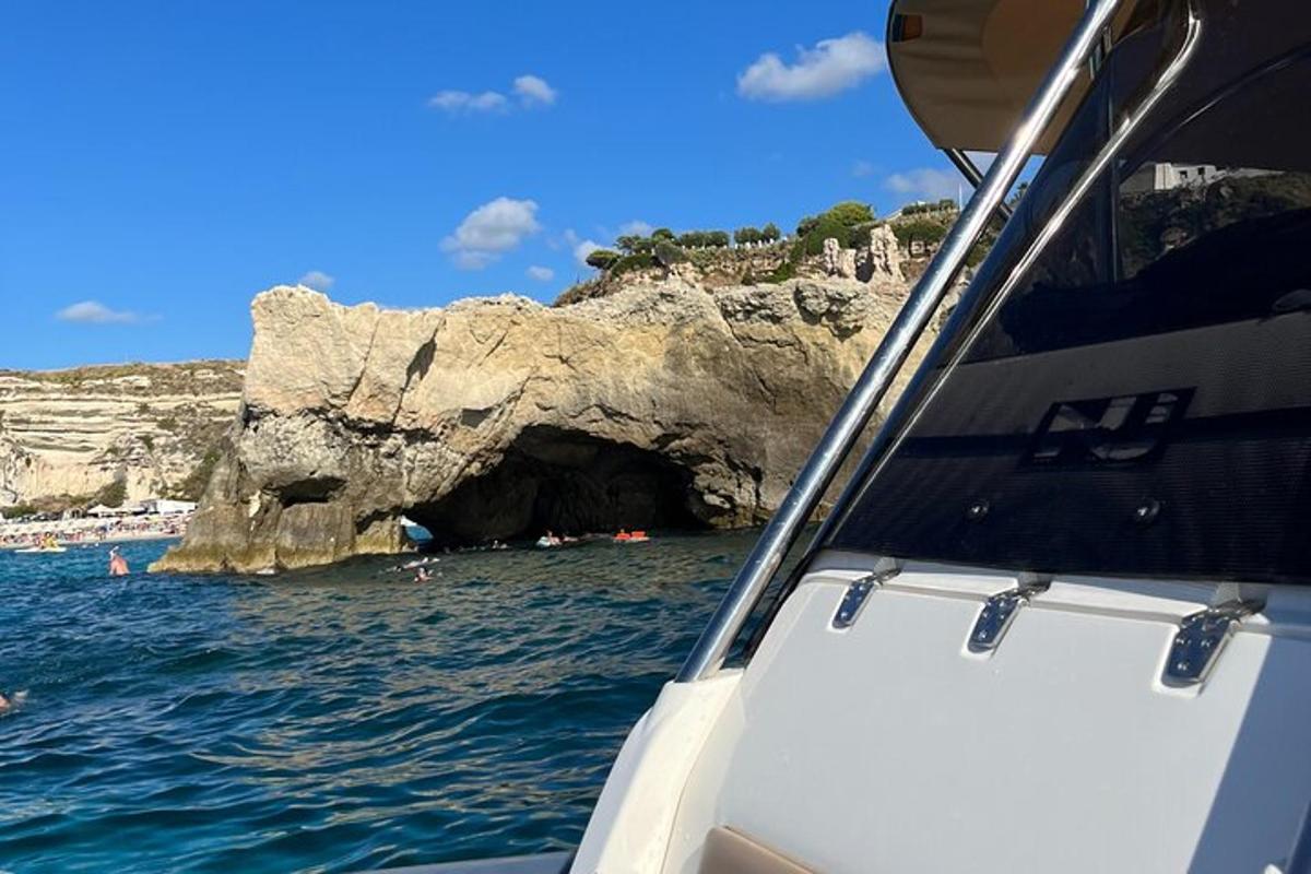 a boat in front of a cave in the water