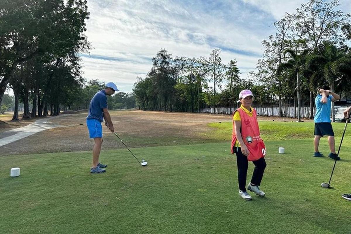 a group of people playing golf on a golf course