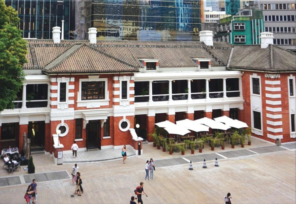 a large building with people walking in front of it