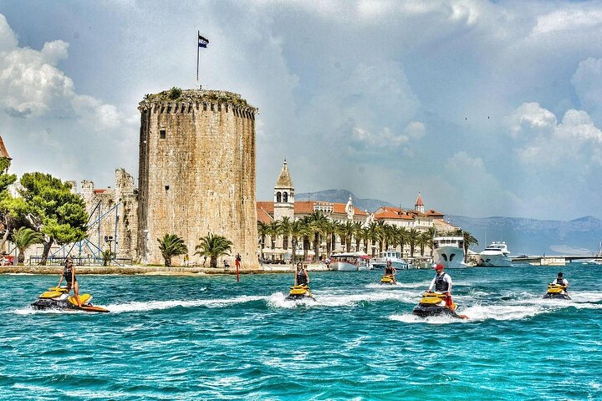 a group of boats in the water in front of a castle