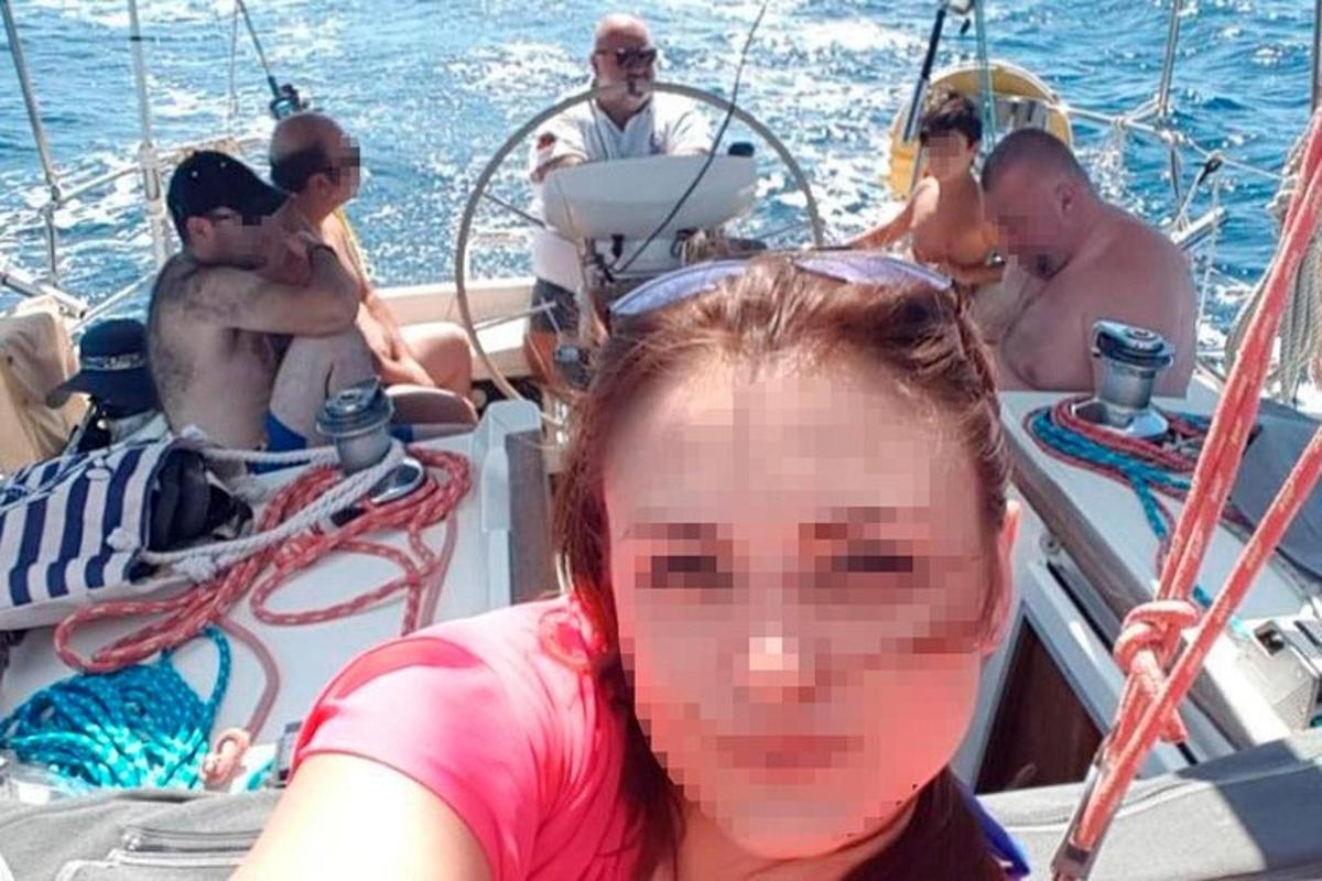 a woman in a pink shirt on a boat