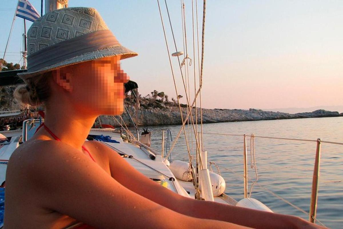 a woman wearing a hat on a boat in the water