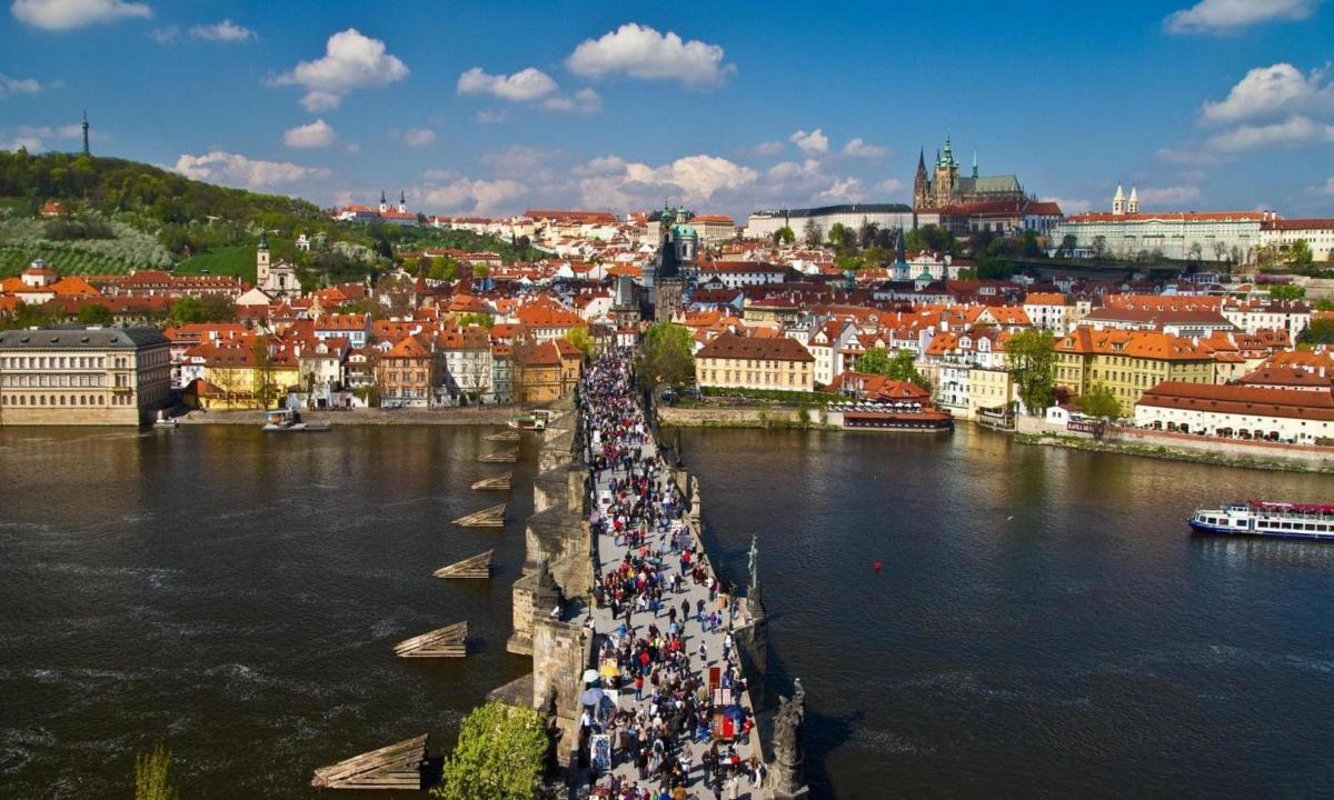 a group of people standing on a bridge over a river