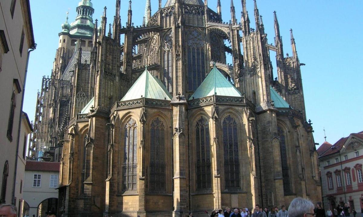 a large cathedral with people standing in front of it
