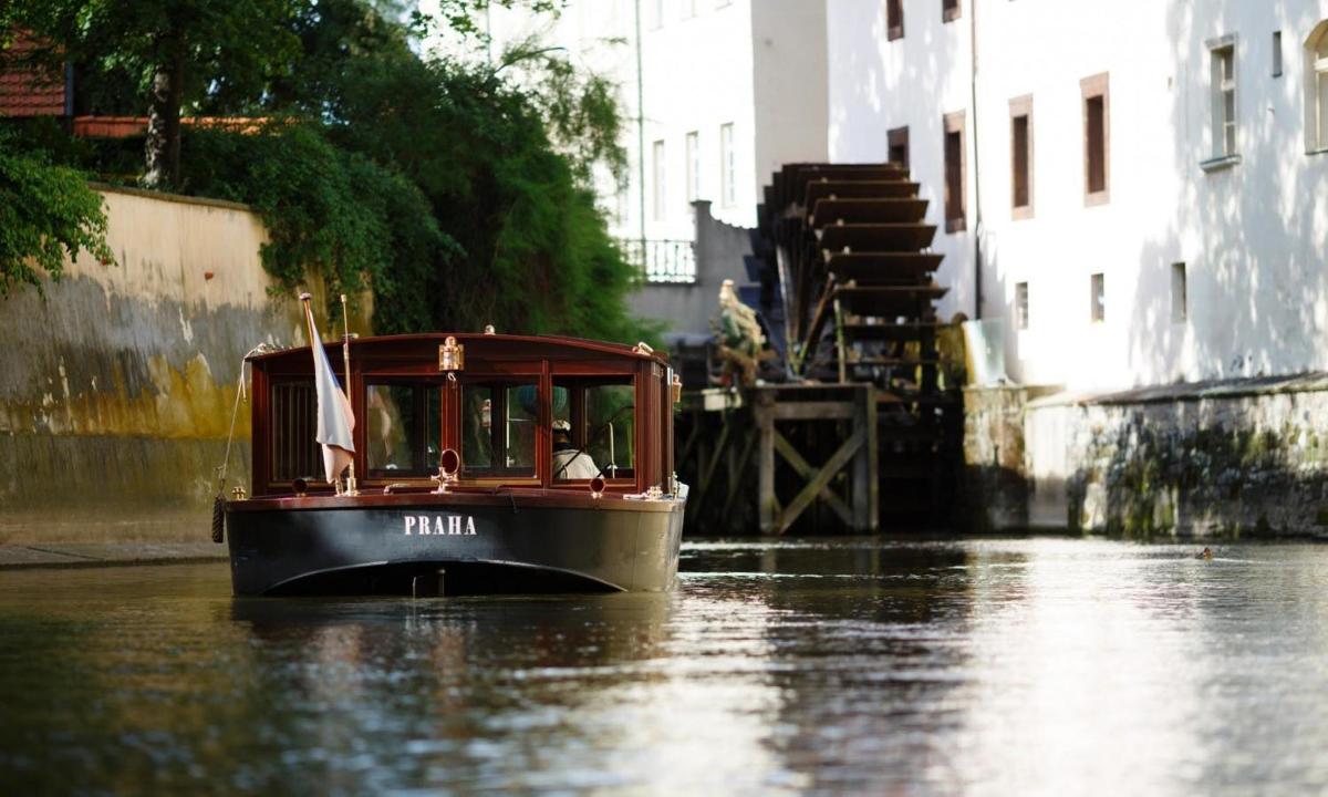 a small boat in the water in a canal