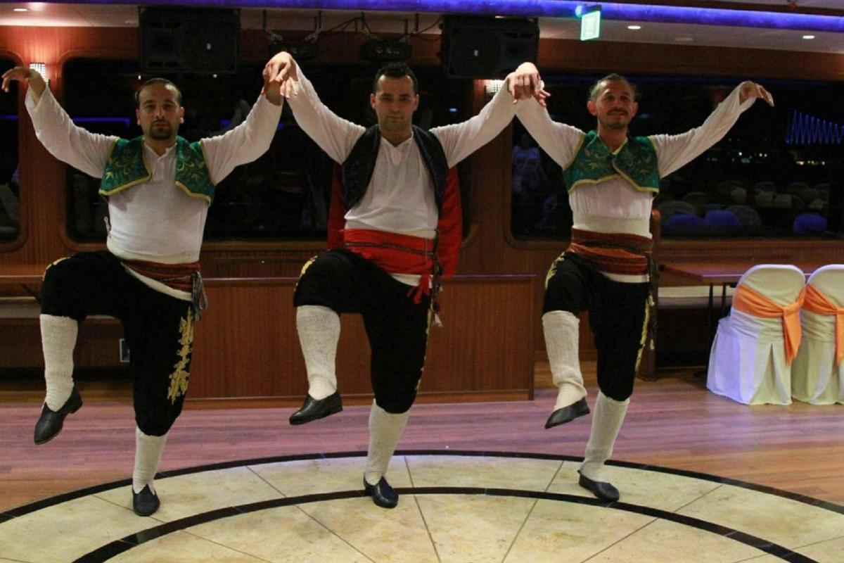 isang grupo ng tatlong lalaki na sumasayaw sa isang dance floor