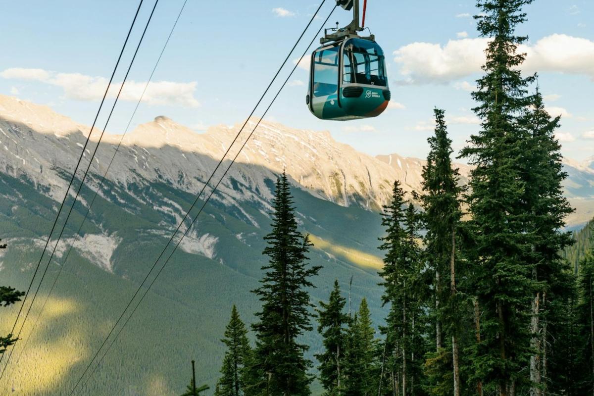 a gondola is flying over a mountain