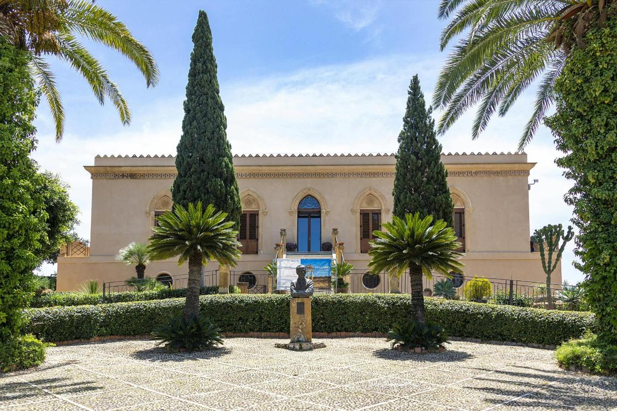 a building with two tall trees in front of it