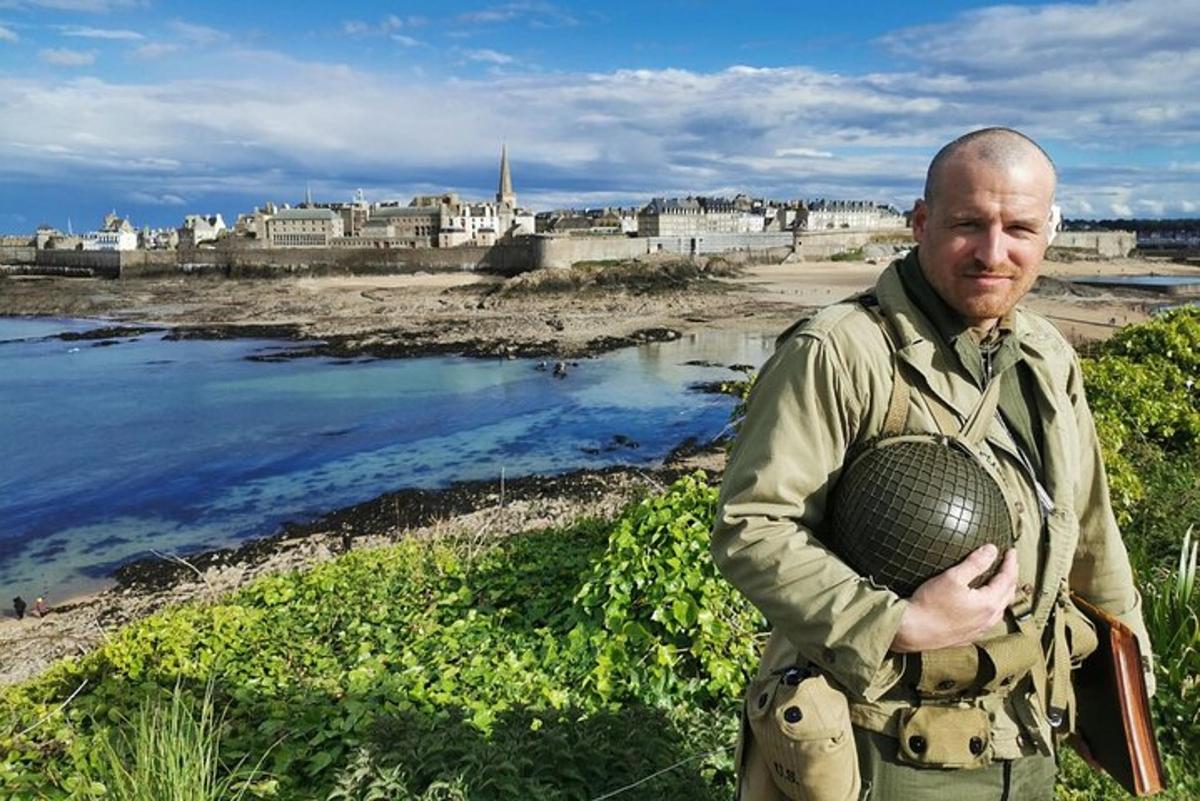 a man standing next to a body of water