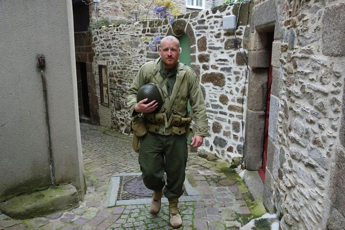 a man is walking down a street with a ball