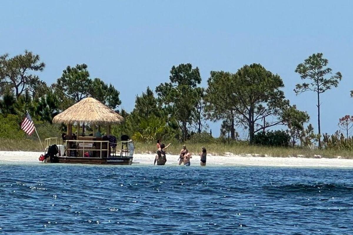 a group of people on a boat on the beach