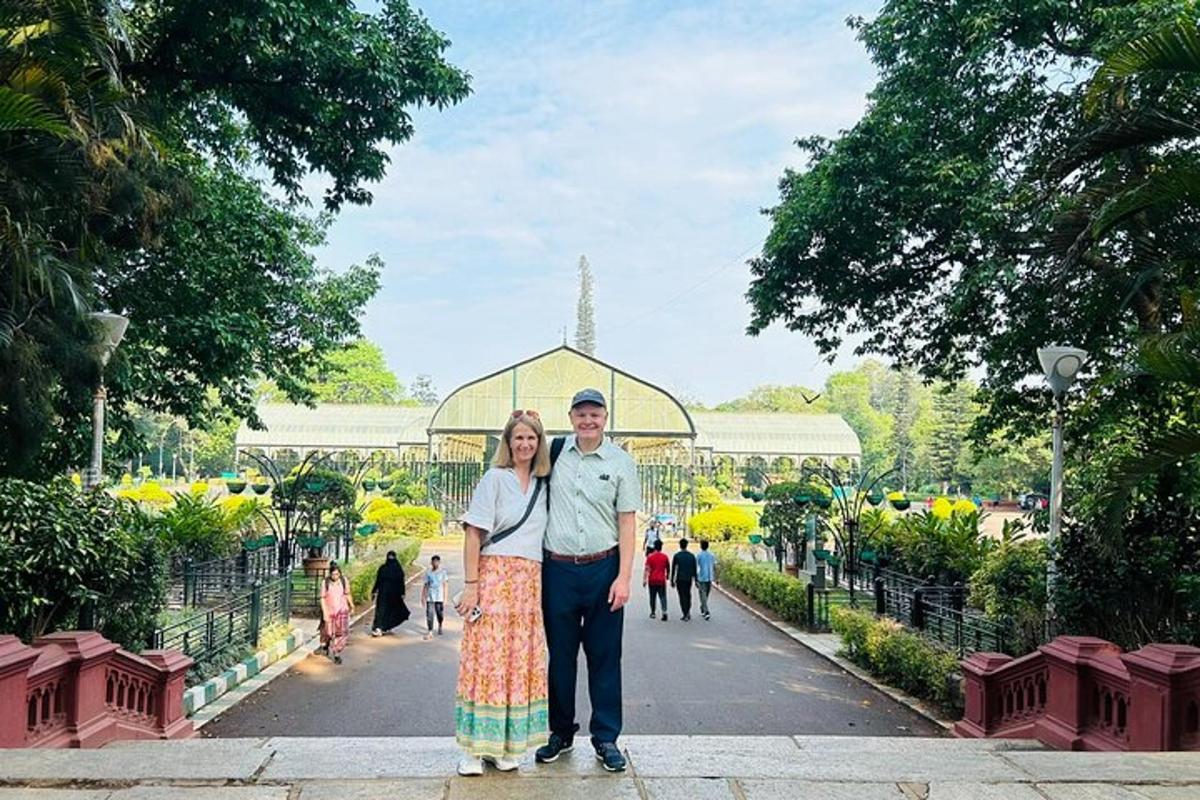 a man and woman standing in front of a garden
