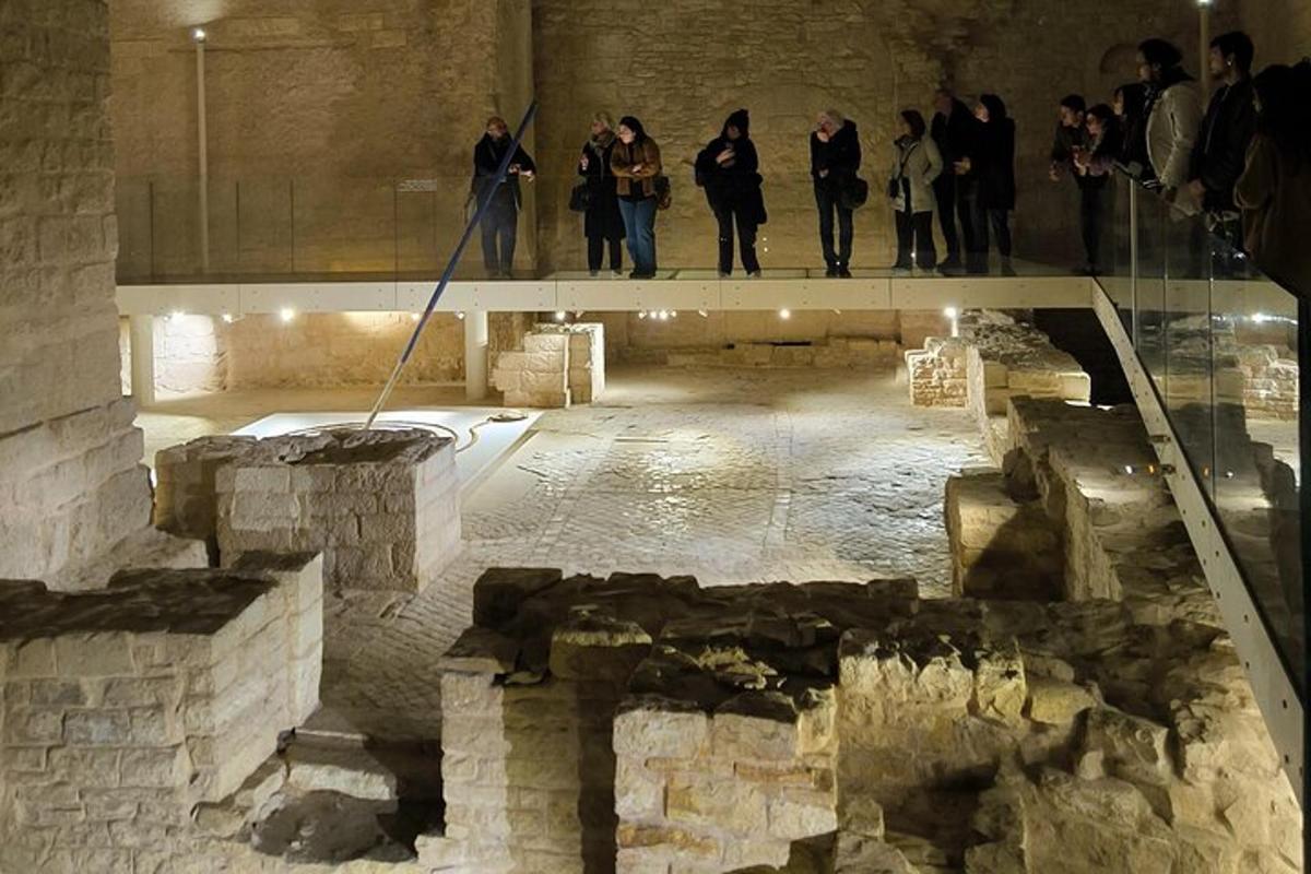 a group of people standing on a glass floor in a museum