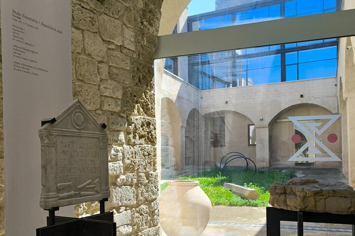 a stone building with a vase and a sign on a wall