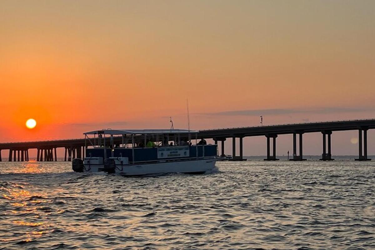 a boat in the water in front of a bridge