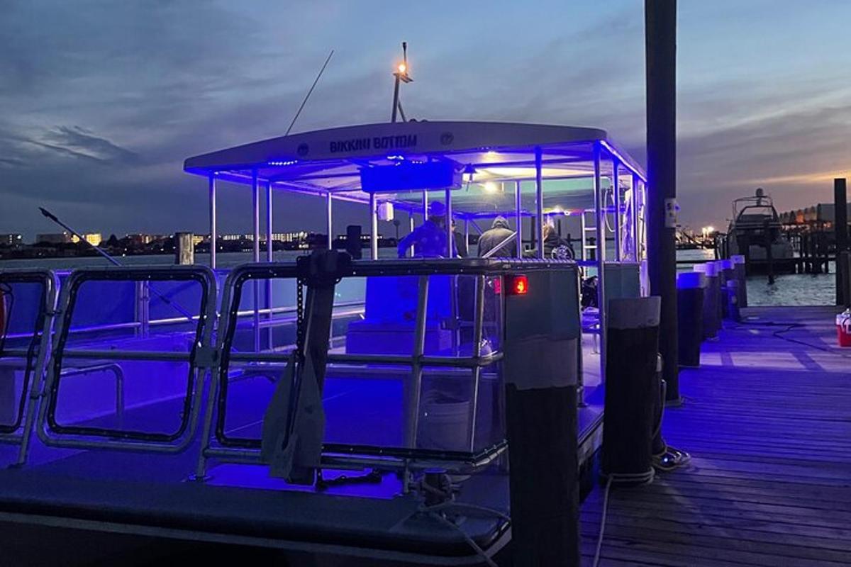 a boat with blue lights on a dock