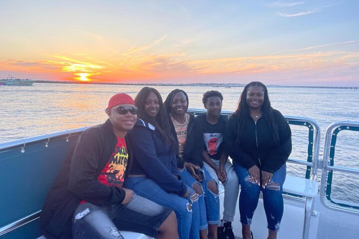 a group of people sitting on a boat in the ocean