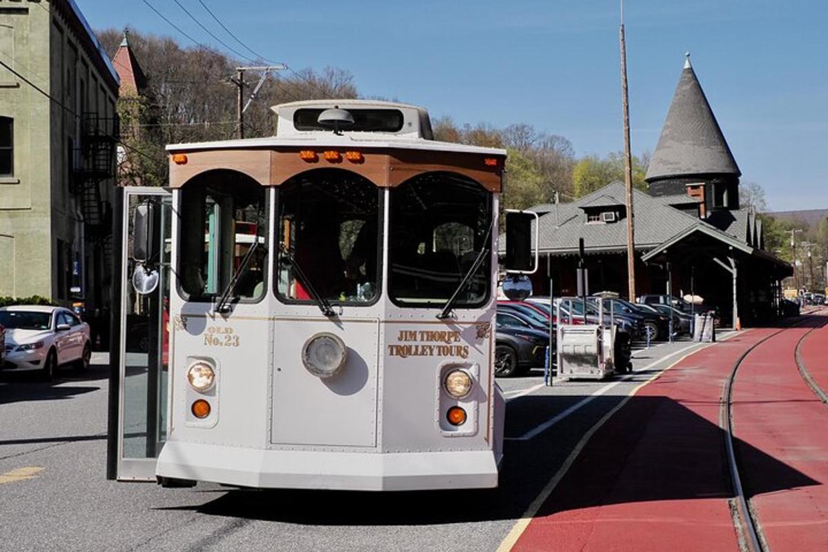 a trolley car is parked on a city street
