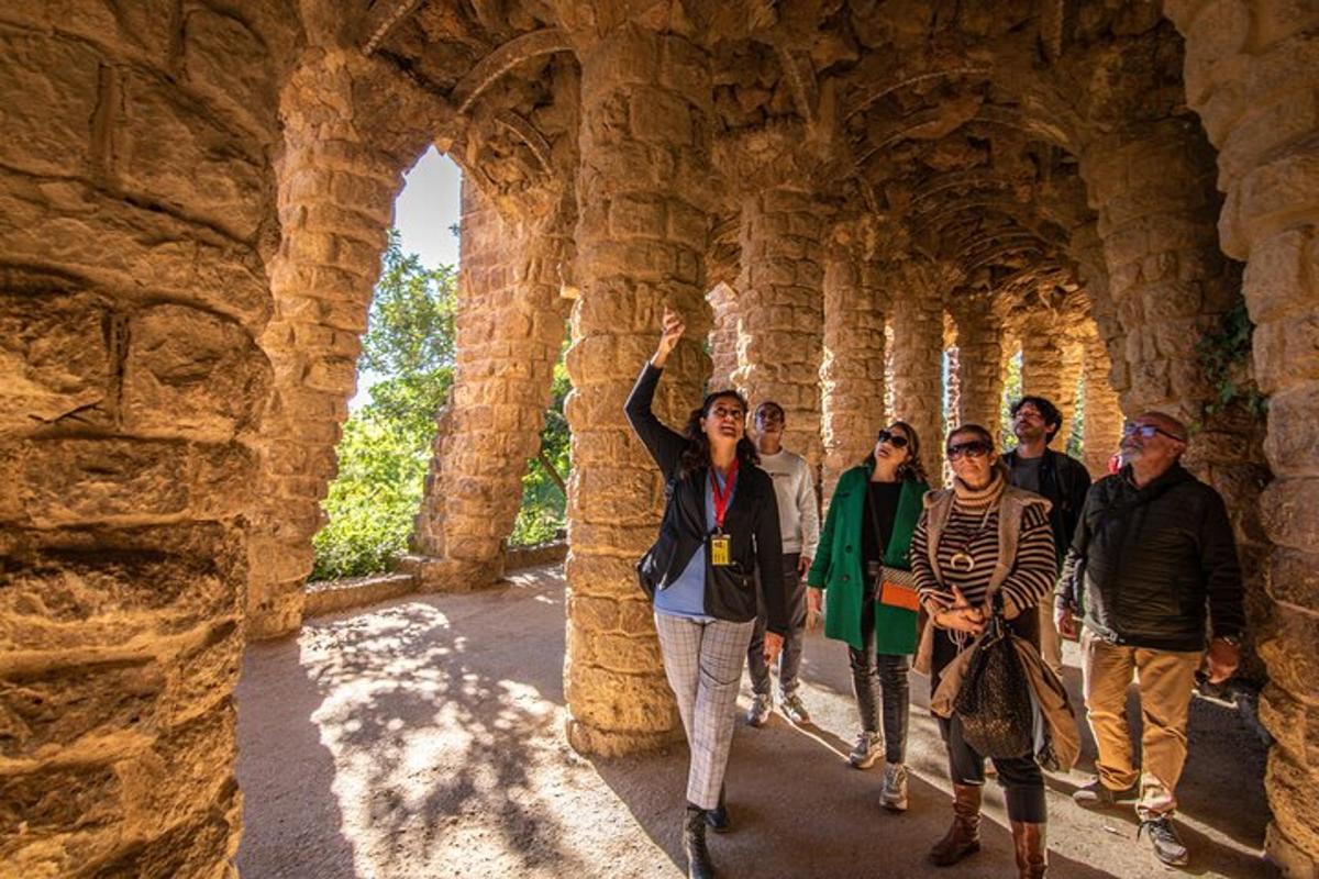 a group of people walking through a stone wall