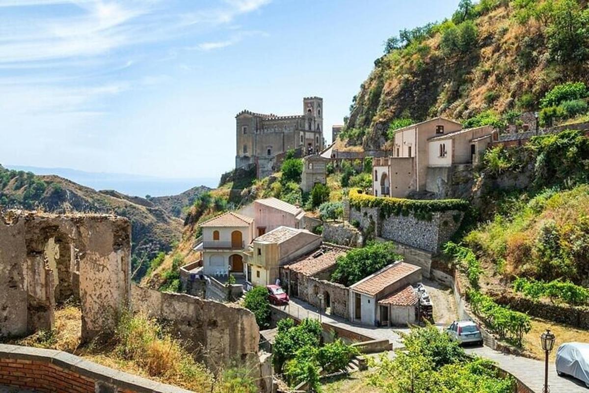a village on a hill with a castle in the background