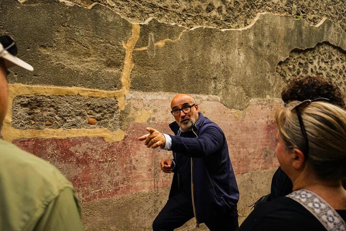 a man pointing at a wall with a woman