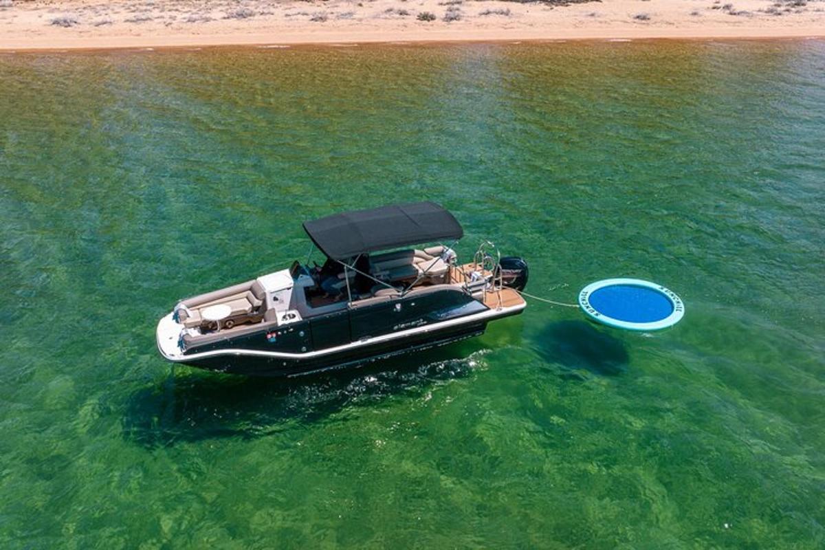 a boat in the water next to a beach