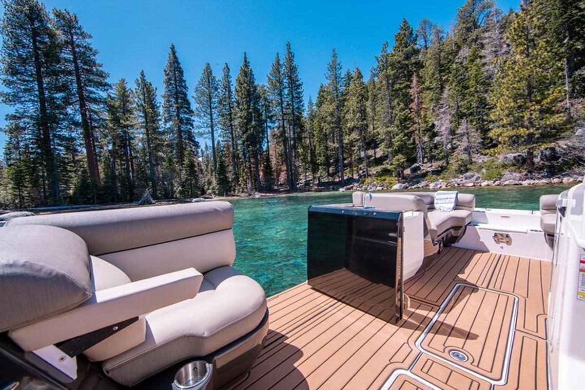 a boat deck with chairs and a television on the water