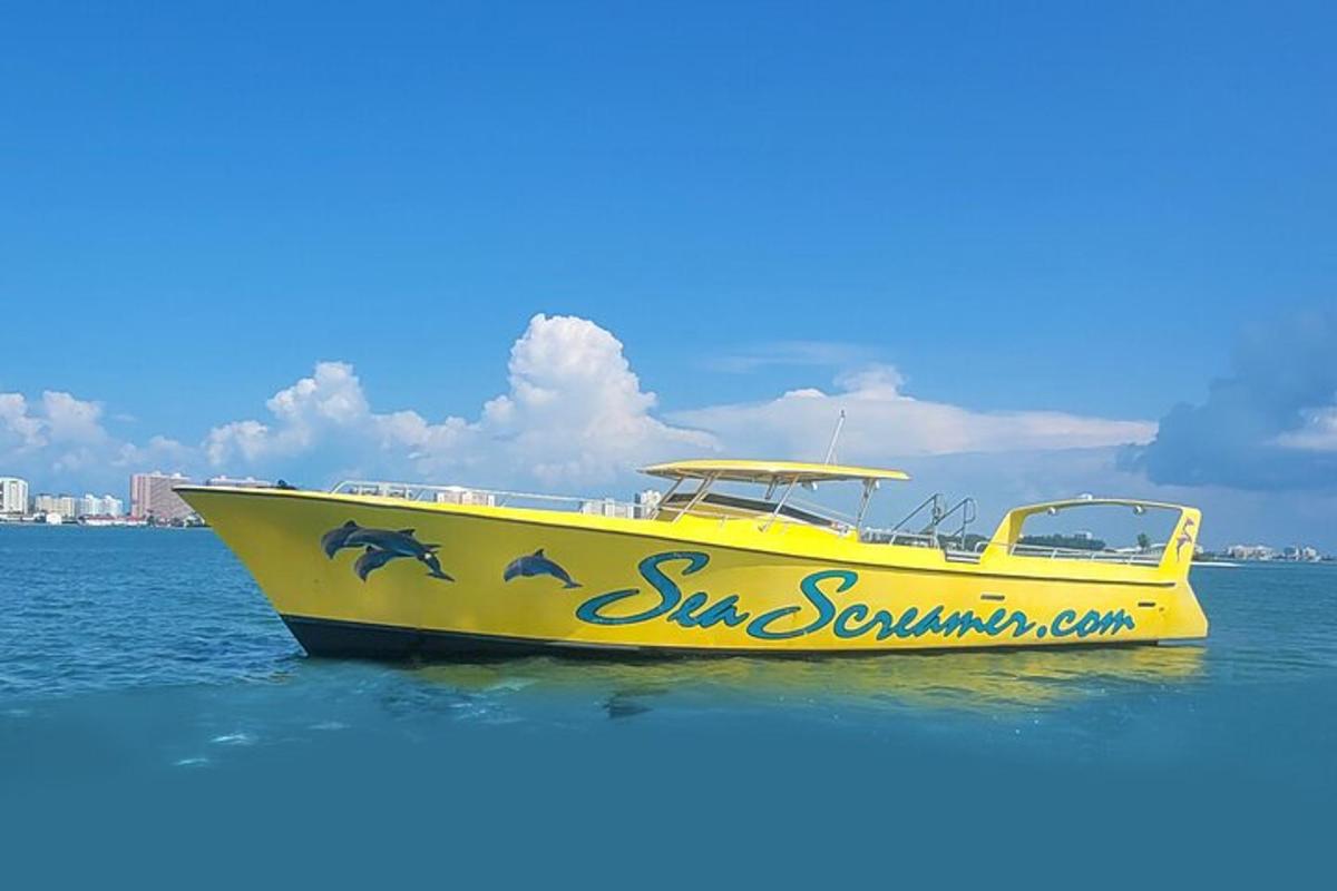 a yellow boat in the water with dolphins on it