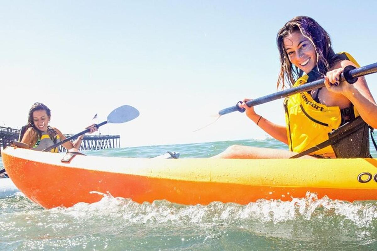 a man and a woman in a kayak in the ocean
