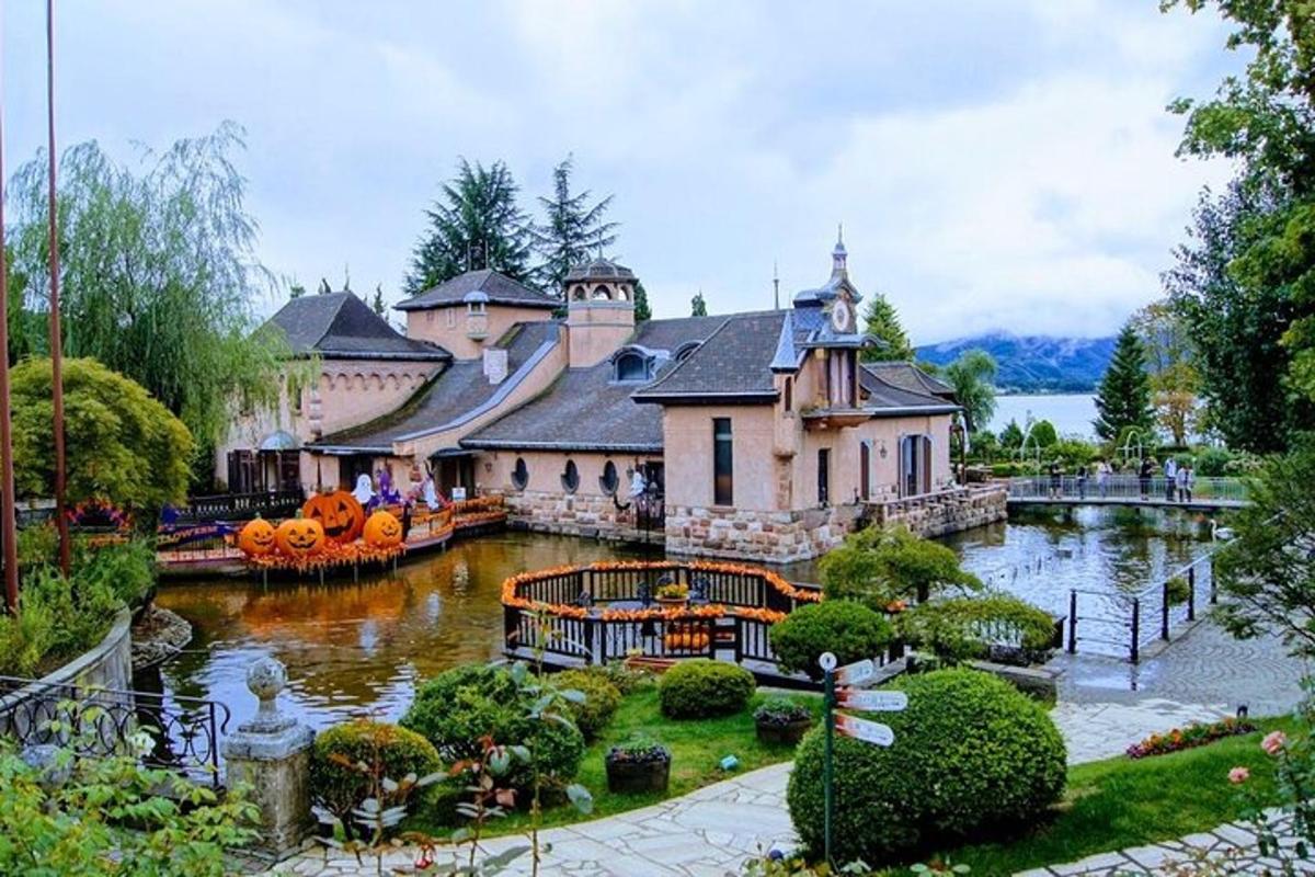 a large house with a pond in front of it