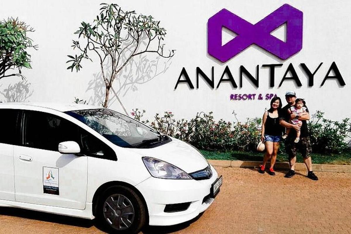 a group of people standing in front of a white car