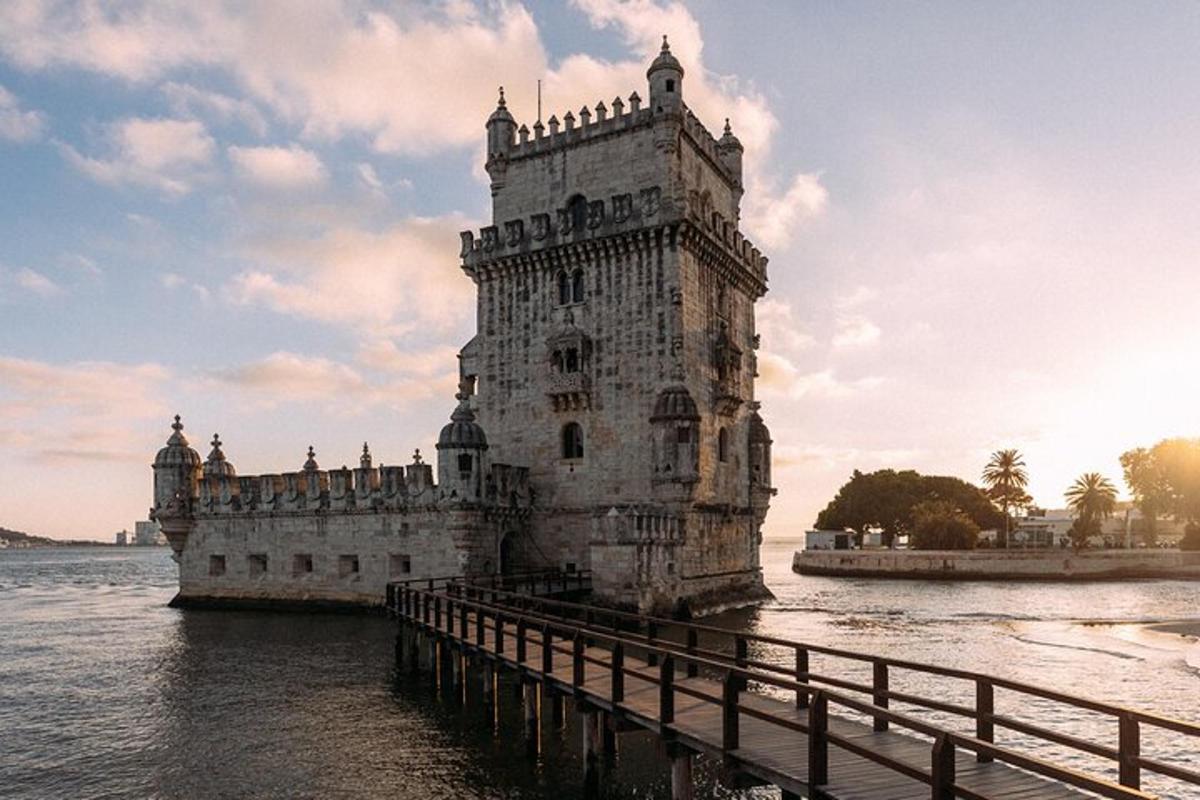 a stone tower in the water next to a bridge